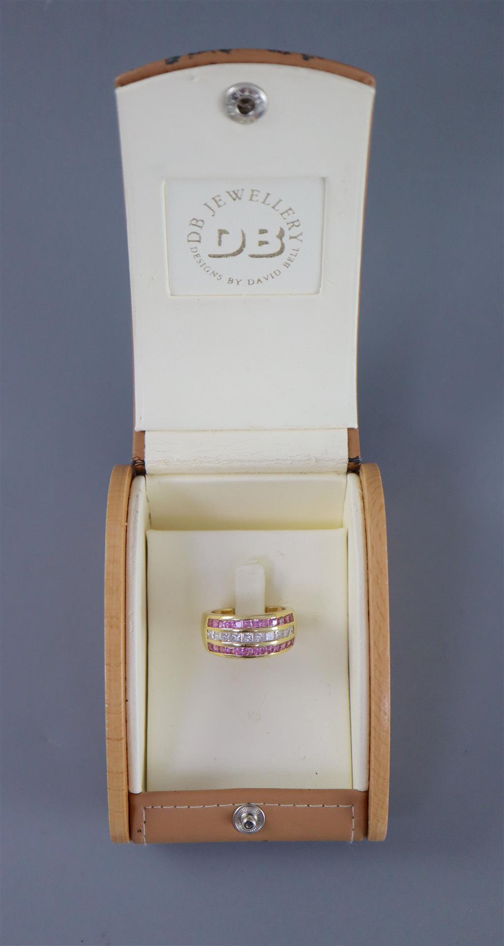 A modern 18ct gold, diamond and pink sapphire set three row dress ring,